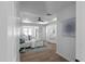 Bright bedroom featuring a tray ceiling, ceiling fan, and modern décor at 7171 Hazelwood Dr, Jonesboro, GA 30236