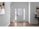 Bright foyer with light walls, wood floors, and a front door that has multiple window panes at 7171 Hazelwood Dr, Jonesboro, GA 30236