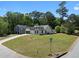 Traditional-style home with a well-manicured lawn and mature trees at 7171 Hazelwood Dr, Jonesboro, GA 30236