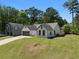 A charming home with a lush lawn, and lengthy driveway next to another residential property at 7171 Hazelwood Dr, Jonesboro, GA 30236