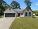 Charming single story home featuring a 2 car garage, manicured lawn, and welcoming front facade at 7171 Hazelwood Dr, Jonesboro, GA 30236