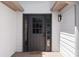 Welcoming front entry with a stylish door and sidelights, complemented by wood siding at 7171 Hazelwood Dr, Jonesboro, GA 30236