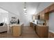 Bright kitchen features wood cabinetry, stainless appliances, marble counters, and a large center island with bar stool seating at 7171 Hazelwood Dr, Jonesboro, GA 30236