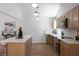 Bright kitchen features wood cabinetry, stainless appliances, marble counters, and a large center island with bar stool seating at 7171 Hazelwood Dr, Jonesboro, GA 30236