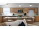 Bright kitchen features wood cabinetry, stainless appliances, marble counters, and a large center island with bar stool seating at 7171 Hazelwood Dr, Jonesboro, GA 30236