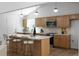 Bright kitchen features wood cabinetry, stainless appliances, marble counters, and a large center island with bar stool seating at 7171 Hazelwood Dr, Jonesboro, GA 30236