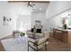 Sunlit living space with stylish furniture, hardwood floors, and a view into the kitchen area at 7171 Hazelwood Dr, Jonesboro, GA 30236