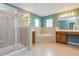 A large, tiled bathroom featuring a glass shower, soaking tub, and separate vanities at 127 Stoney Creek Pkwy, Woodstock, GA 30188