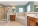 A large bathroom showcases a glass enclosed shower, soaking tub, and dual sink vanities at 127 Stoney Creek Pkwy, Woodstock, GA 30188