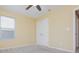 Neutral bedroom with a ceiling fan, closet, and window allowing natural light to flow in at 127 Stoney Creek Pkwy, Woodstock, GA 30188