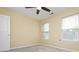 Cozy bedroom with neutral carpet, ceiling fan and two bright windows at 127 Stoney Creek Pkwy, Woodstock, GA 30188