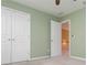 Spacious bedroom with a ceiling fan, plush carpet, and an open doorway at 127 Stoney Creek Pkwy, Woodstock, GA 30188