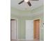 Bright bedroom with ceiling fan and two doors, creating a spacious and airy feel at 127 Stoney Creek Pkwy, Woodstock, GA 30188