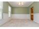Empty dining room showcasing wall trim, a chandelier, neutral carpet, and olive green walls at 127 Stoney Creek Pkwy, Woodstock, GA 30188