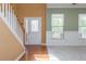 Bright entryway with hardwood and carpet flooring, a white front door, and natural light from the windows at 127 Stoney Creek Pkwy, Woodstock, GA 30188