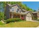 View of a two-story home with neutral siding, a brick porch, and an attached two-car garage at 127 Stoney Creek Pkwy, Woodstock, GA 30188