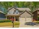 Charming two-story home with a well-manicured lawn and a welcoming front porch at 127 Stoney Creek Pkwy, Woodstock, GA 30188
