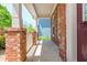 Close-up view of a brick front porch with white pillars and a partial view of the front door at 127 Stoney Creek Pkwy, Woodstock, GA 30188