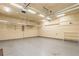 Spacious two-car garage featuring overhead storage and ample lighting at 127 Stoney Creek Pkwy, Woodstock, GA 30188