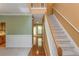 Hallway with stairwell and adjacent hardwood flooring at 127 Stoney Creek Pkwy, Woodstock, GA 30188