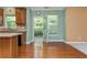Well-lit kitchen showing a kitchen island and leading to a backyard through French doors at 127 Stoney Creek Pkwy, Woodstock, GA 30188