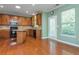 Bright kitchen features stainless appliances, granite counters, wood floors, and direct access to the outdoors at 127 Stoney Creek Pkwy, Woodstock, GA 30188