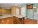 Kitchen island with wood base and granite countertop next to a living area and dining area at 127 Stoney Creek Pkwy, Woodstock, GA 30188