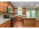 Well-equipped kitchen boasts granite countertops, stainless appliances, and ample cabinet space at 127 Stoney Creek Pkwy, Woodstock, GA 30188