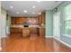 Spacious kitchen featuring wood floors, wood cabinets, an island, and stainless steel appliances at 127 Stoney Creek Pkwy, Woodstock, GA 30188