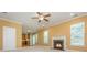 Open concept living room featuring a fireplace, ceiling fan, and view of the kitchen at 127 Stoney Creek Pkwy, Woodstock, GA 30188