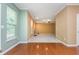 Open-concept living space with hardwood floors that connect to a carpeted living room with a fireplace at 127 Stoney Creek Pkwy, Woodstock, GA 30188