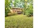 Spacious backyard featuring mature trees, a lush green lawn, and a trampoline for outdoor fun, enhancing the home's appeal at 1901 Arnold Dr, Austell, GA 30106