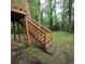 Wooden staircase leading to a backyard with lush greenery at 1901 Arnold Dr, Austell, GA 30106