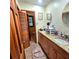Updated bathroom boasts granite countertops, tile flooring and wooden cabinets at 1901 Arnold Dr, Austell, GA 30106