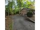 Long driveway leading to a two-car garage and a house surrounded by lush trees, offering privacy and convenience at 1901 Arnold Dr, Austell, GA 30106
