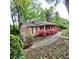 Brick home with lush green landscaping and a cozy, covered front porch at 1901 Arnold Dr, Austell, GA 30106