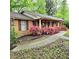 Charming brick home with a covered porch, blossoming azaleas, and a manicured lawn at 1901 Arnold Dr, Austell, GA 30106