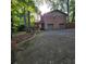 Spacious driveway leads to a two-car garage, with a charming deck above, blending convenience with outdoor living space at 1901 Arnold Dr, Austell, GA 30106