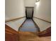 Stairwell with wooden handrail and hardwood floors leads to the basement at 1901 Arnold Dr, Austell, GA 30106