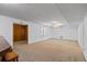 Spacious finished basement with neutral carpeting, white walls, and wood paneling throughout at 350 Covered Bridge Sw Pl, Smyrna, GA 30082