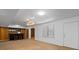 Finished basement area with a bar setup, carpet flooring, and a door to the exterior at 350 Covered Bridge Sw Pl, Smyrna, GA 30082