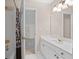 A bathroom featuring a vanity with a white countertop and gold faucet, along with a shower at 350 Covered Bridge Sw Pl, Smyrna, GA 30082