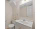 Bathroom featuring a toilet, sink and white vanity with silver faucet and a mirror at 350 Covered Bridge Sw Pl, Smyrna, GA 30082