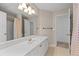 Bathroom featuring a vanity with a white countertop and gold faucet, a shower and a doorway at 350 Covered Bridge Sw Pl, Smyrna, GA 30082