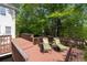Large deck with lounge chairs overlooking a wooded backyard, perfect for enjoying the outdoors at 350 Covered Bridge Sw Pl, Smyrna, GA 30082