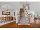 A bright foyer with staircase, hardwood floors, and an open dining area at 350 Covered Bridge Sw Pl, Smyrna, GA 30082