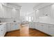 Spacious kitchen features stainless appliances, granite counters, and hardwood floors at 350 Covered Bridge Sw Pl, Smyrna, GA 30082