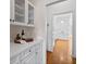 Bright kitchen featuring custom cabinets, white countertops, and hardwood floors at 350 Covered Bridge Sw Pl, Smyrna, GA 30082