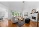 Elegant living room boasting a fireplace, large windows, and hardwood floors at 350 Covered Bridge Sw Pl, Smyrna, GA 30082