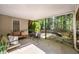 Covered patio with seating, stone flooring, and a view of the wooded backyard at 350 Covered Bridge Sw Pl, Smyrna, GA 30082